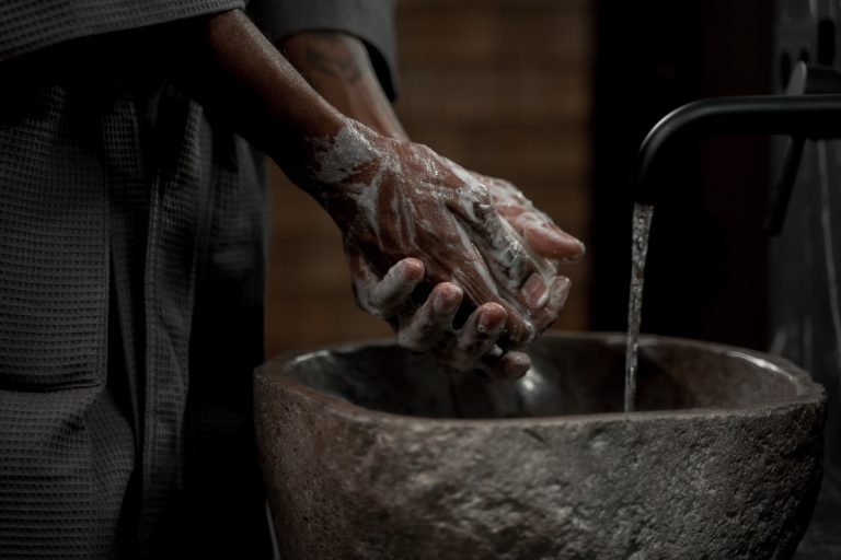 Une personne se nettoie les mains grâce à de l'eau chauffée par un chauffe-eau thermodynamique